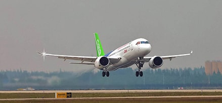 Airplane landing with green tail