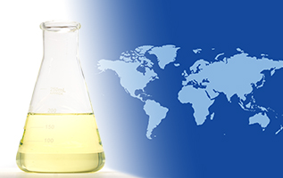 A laboratory flask with EHC 340 MAX base stock on the foreground of a two-tone global map.