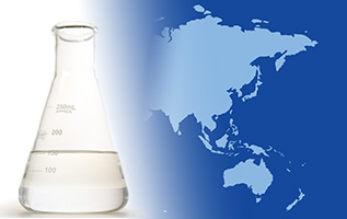 A laboratory flask with EHC 50/120 base stock on the foreground of a two-tone map of Asia and Australia.