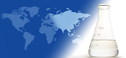 A laboratory flask with EHC 50/110 base stock on the foreground of a two-tone global map highlighting Asia and Australia.