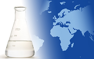 A laboratory flask with EHC 50/120 base stock on the foreground of a two-tone map of Europe and Africa.