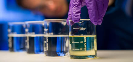 An ExxonMobil basestocks employee measuring liquids in beakers
