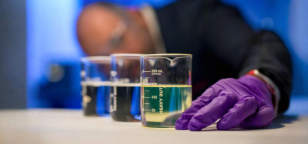 An ExxonMobil basestocks employee measuring liquids in beakers