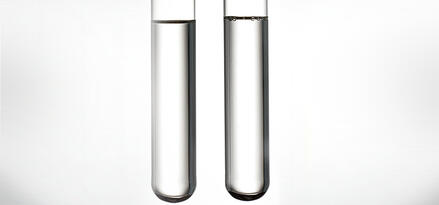 two tubes with white liquid inside