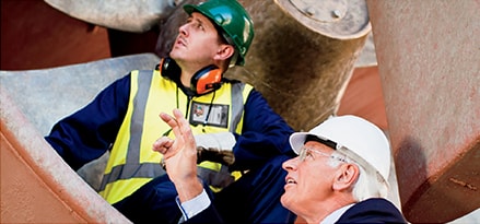 Workers in front of a fan
