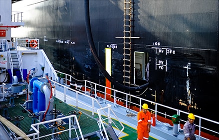 Ship crew working on the side of the ship