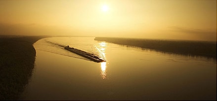 Ship in the river during a sunset