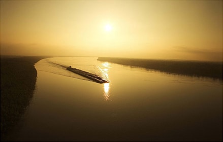 Ship in the river during a sunset