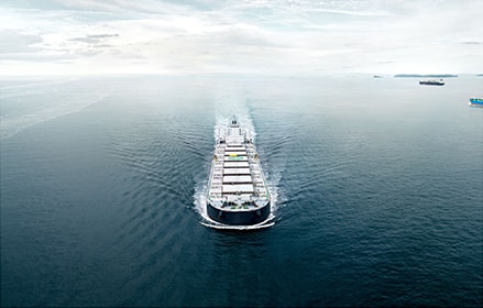 Front aerial view on container ship in the water