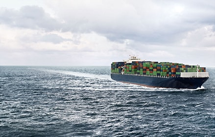 Container ship with cargo on open water