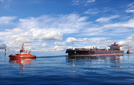Tanker ship guided by tug boats