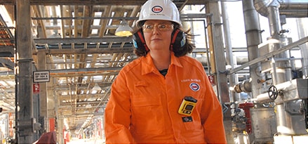 Female refinery worker with hardhat