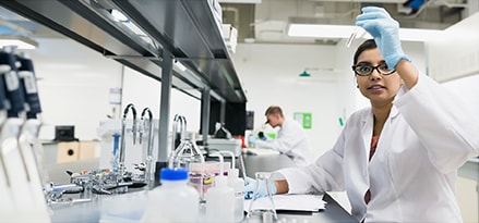 Scientist examining liquid in a test tube in laboratory