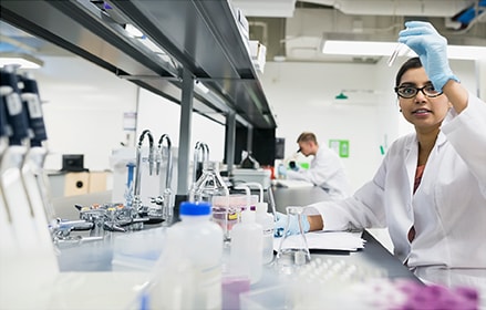 Scientist examining liquid in test tube in laboratory