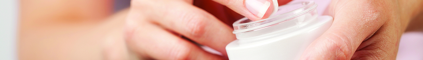 Woman applying hand cream Woman applying hand cream