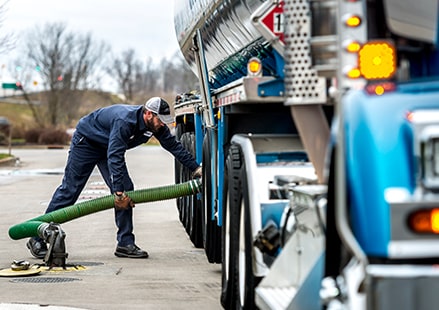 an image of man pumping fuel from a truck